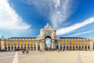 a group of people in front of a large building with Praça do Comércio in the background
