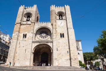 a large tall tower with a clock at the top of a building