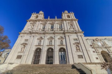 a large tall tower with a clock on the side of a building