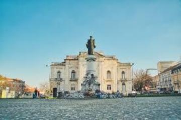a large body of water with a city in the background