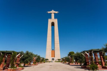 a large tall tower with a clock on the side of a building